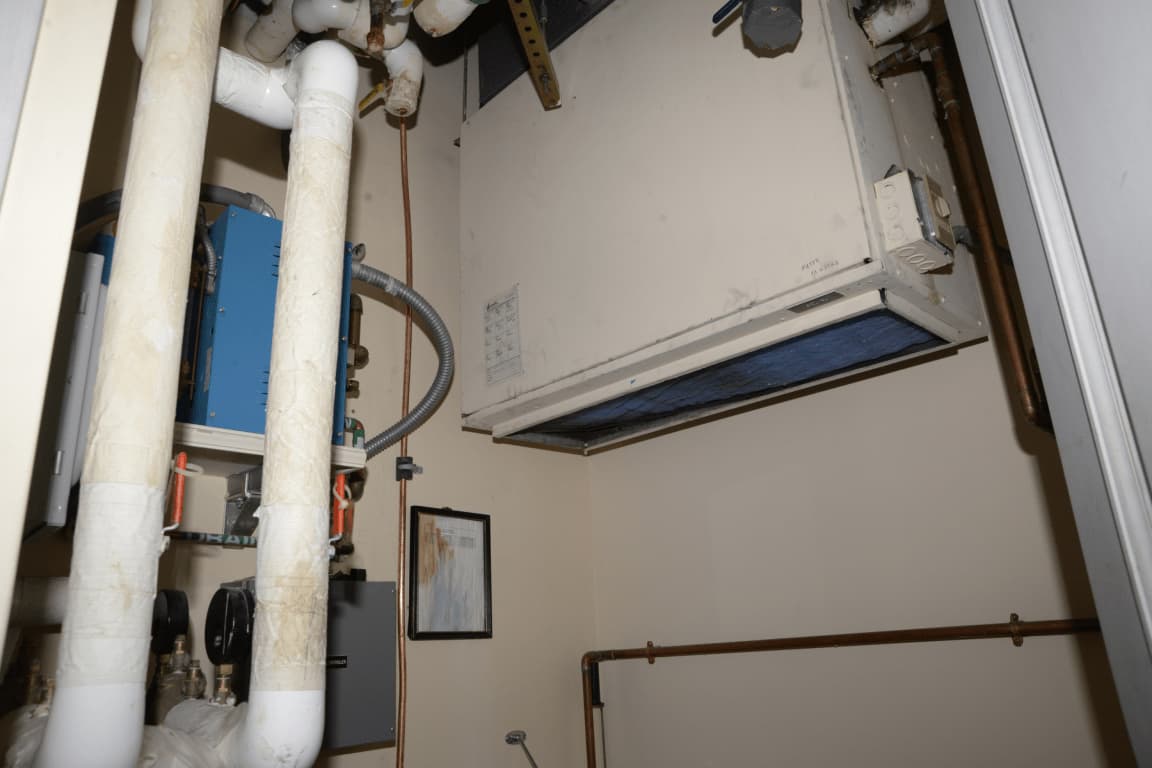 After: a tidy plant room with clean, labelled pipe runs and modern equipment