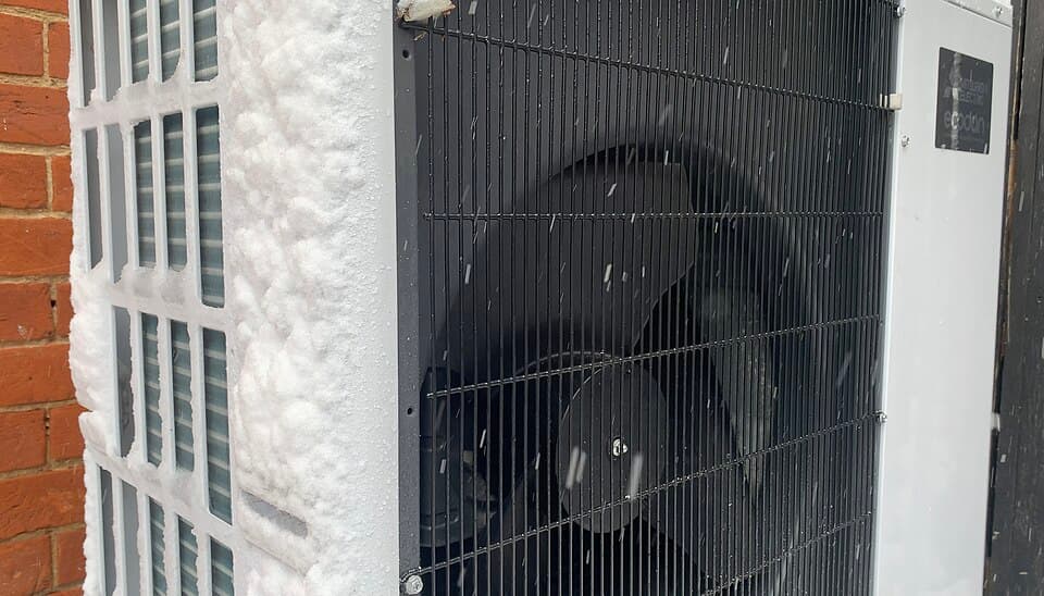 Outdoor heat pump unit running in snow