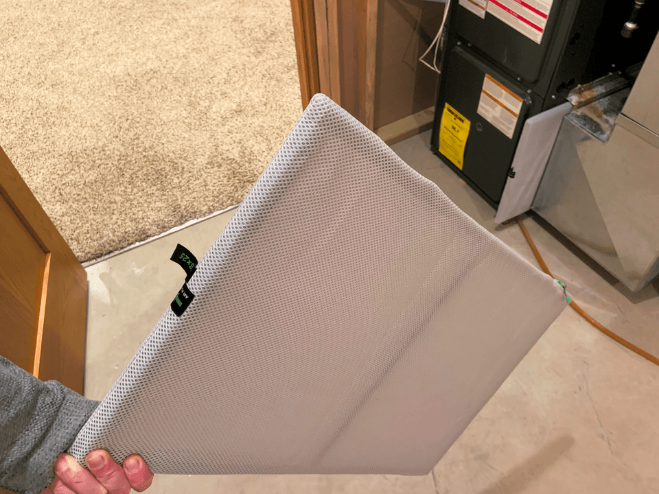 Pleated HVAC air filter removed from its housing