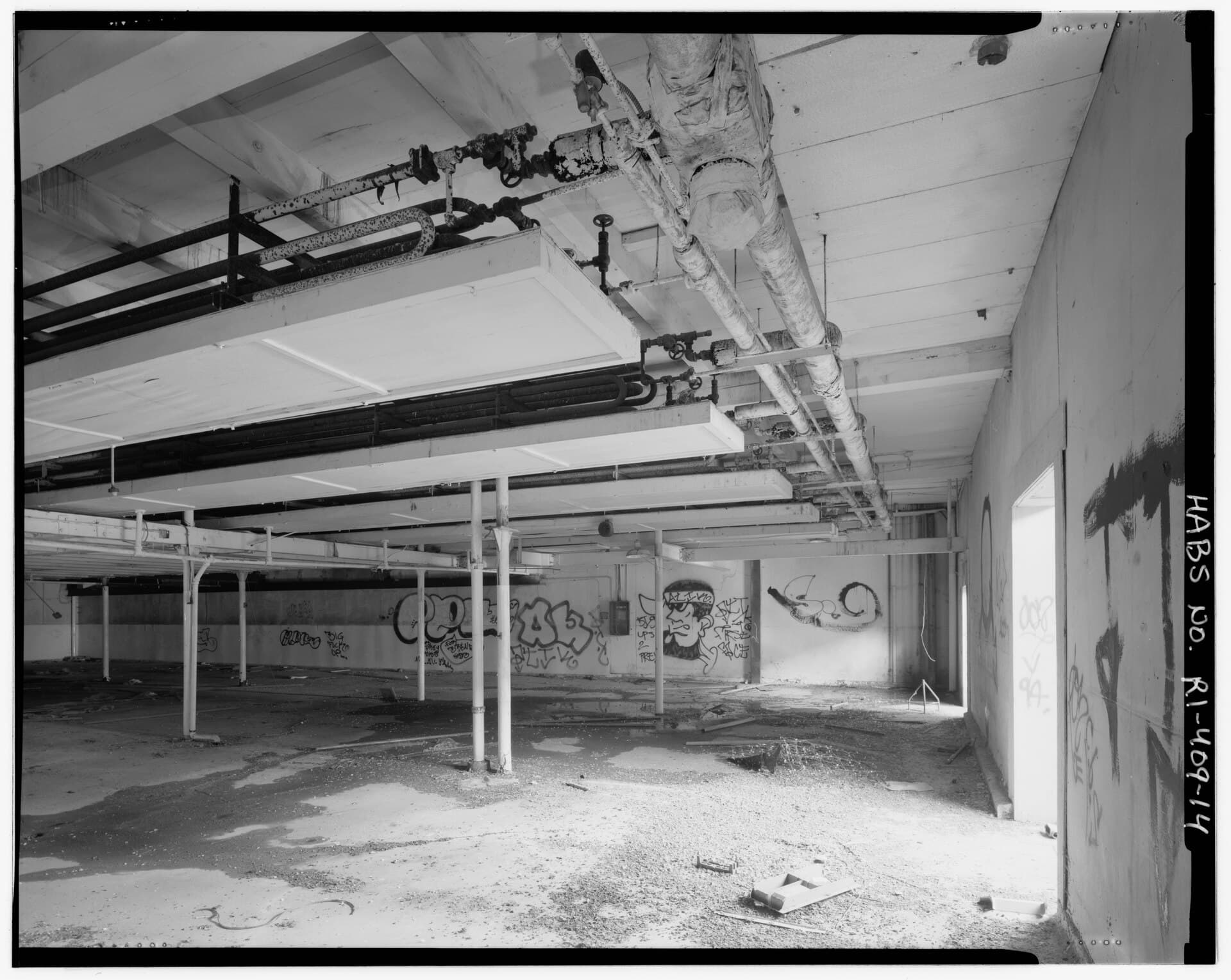 High-bay warehouse interior with mechanical services running along the ceiling